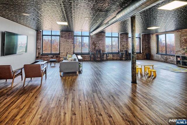 518-536 Gregory Ave Unit C408, Weehawken, NJ 07086 - living room with brick wall, an ornate ceiling, and wood finished floors