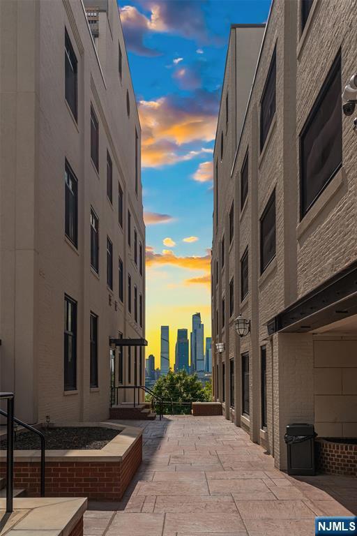 518-536 Gregory Ave Unit C408, Weehawken, NJ 07086 - property at dusk featuring a skyline view