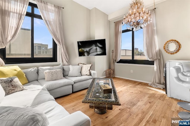 518-536 Gregory Ave Unit C408, Weehawken, NJ 07086 - living area with a chandelier, wood-type flooring, plenty of natural light, and baseboards