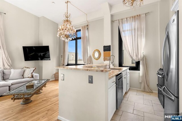 518-536 Gregory Ave Unit C408, Weehawken, NJ 07086 - kitchen with a chandelier, freestanding refrigerator, double oven range, open floor plan, and light stone countertops