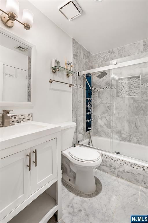 518-536 Gregory Ave Unit C408, Weehawken, NJ 07086 - full bath featuring toilet, tiled shower / bath combo, and vanity