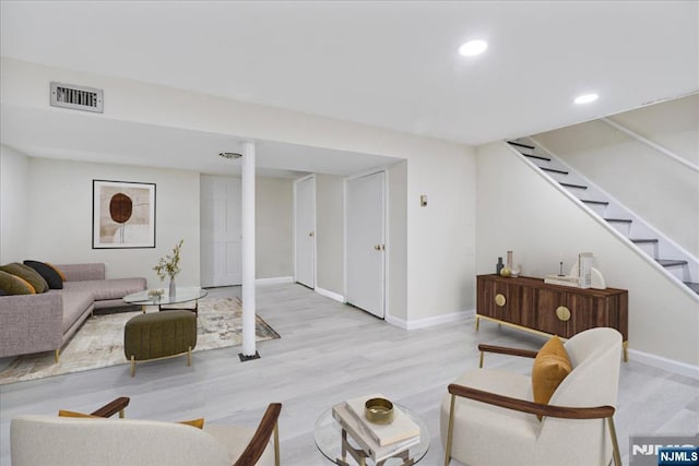 living area featuring visible vents, wood finished floors, stairway, baseboards, and recessed lighting
