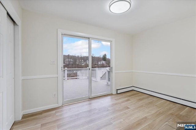 interior space with baseboard heating and light wood-style flooring