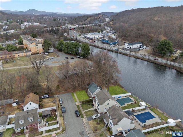 drone / aerial view featuring a water and mountain view