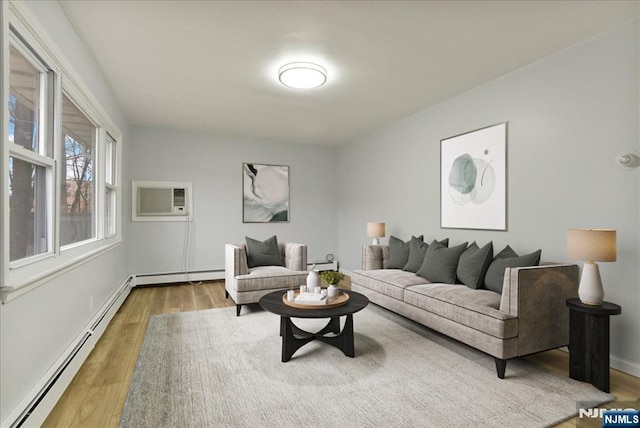 living area with baseboards, a wall mounted air conditioner, baseboard heating, and wood finished floors