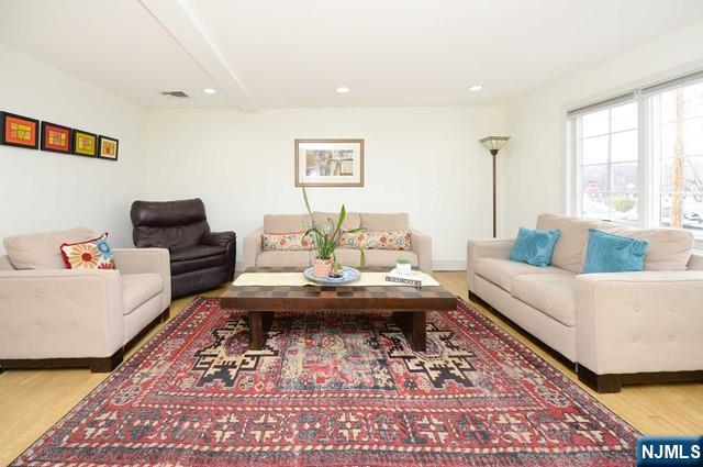 1-06 Lambert Rd, Fair Lawn, NJ 07410 - living room featuring beamed ceiling, recessed lighting, wood finished floors, and visible vents