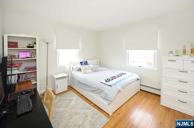 1-06 Lambert Rd, Fair Lawn, NJ 07410 - bedroom featuring a baseboard radiator and light wood finished floors