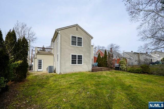 1-06 Lambert Rd, Fair Lawn, NJ 07410 - rear view of property featuring a yard, a deck, and cooling unit