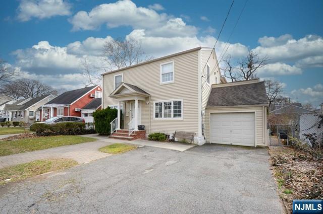 1-06 Lambert Rd, Fair Lawn, NJ 07410 - view of front of home with a garage, driveway, and a residential view