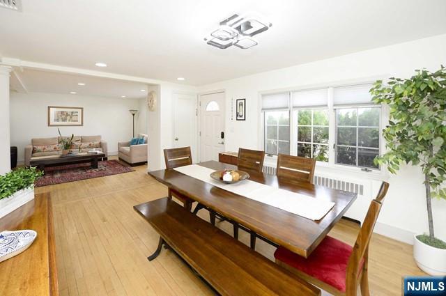 1-06 Lambert Rd, Fair Lawn, NJ 07410 - dining space featuring recessed lighting, visible vents, radiator heating unit, and light wood-style flooring