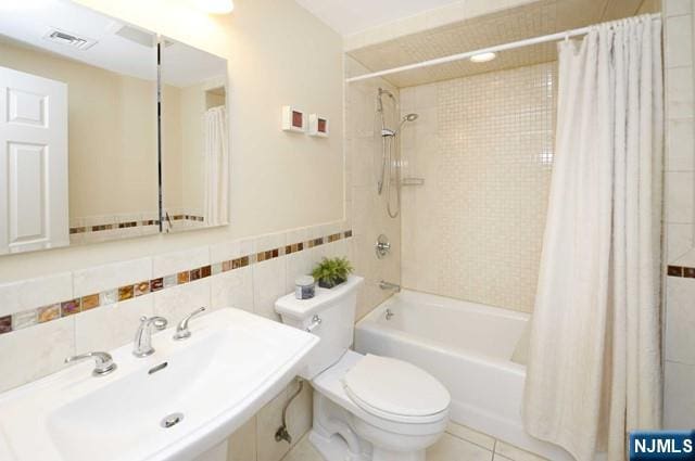 1-06 Lambert Rd, Fair Lawn, NJ 07410 - bathroom with visible vents, tile walls, shower / tub combo, a sink, and toilet