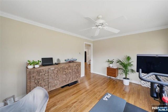 interior space featuring ceiling fan, baseboards, wood finished floors, visible vents, and ornamental molding
