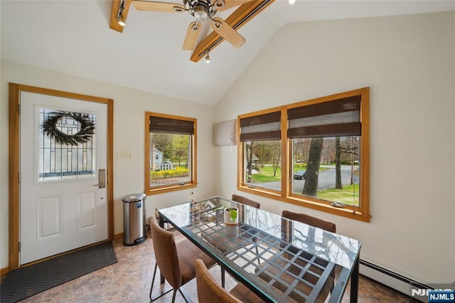 dining room with ceiling fan, track lighting, baseboard heating, baseboards, and vaulted ceiling