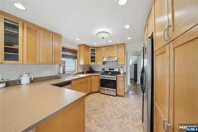 kitchen with tasteful backsplash, a sink, under cabinet range hood, light brown cabinets, and stainless steel appliances