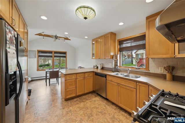 kitchen featuring stainless steel dishwasher, a peninsula, fridge with ice dispenser, a sink, and exhaust hood
