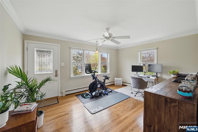 workout area with crown molding, baseboards, ceiling fan, a baseboard heating unit, and light wood-style flooring