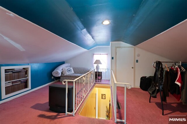 bonus room with carpet floors and vaulted ceiling