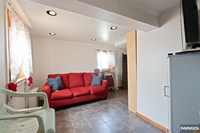 living room featuring recessed lighting, baseboards, and tile patterned floors