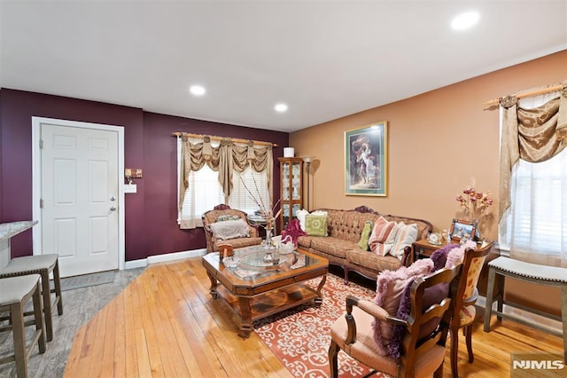 living room with recessed lighting, baseboards, and hardwood / wood-style flooring