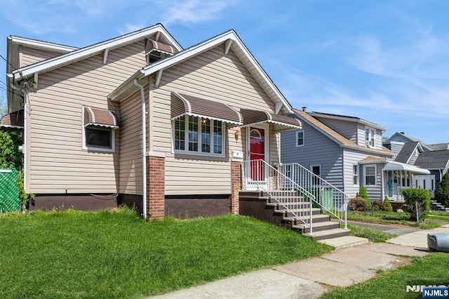 bungalow-style home with a front yard
