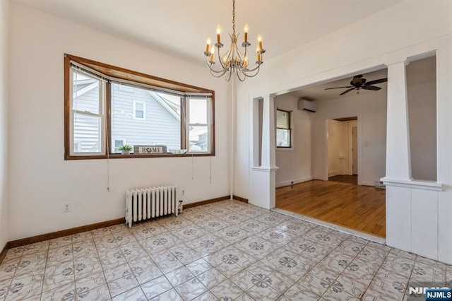 spare room featuring radiator, decorative columns, baseboards, a wall mounted AC, and ceiling fan with notable chandelier
