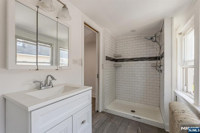 bathroom featuring vanity, a stall shower, and radiator