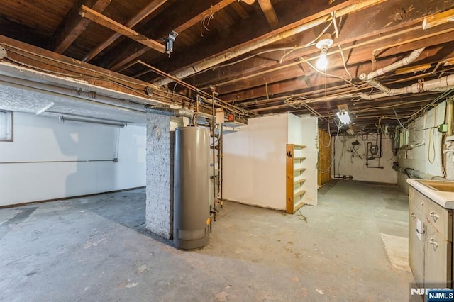 unfinished basement with water heater and stairs