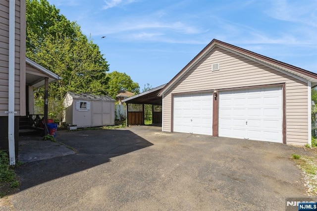 garage with a detached garage and a storage unit