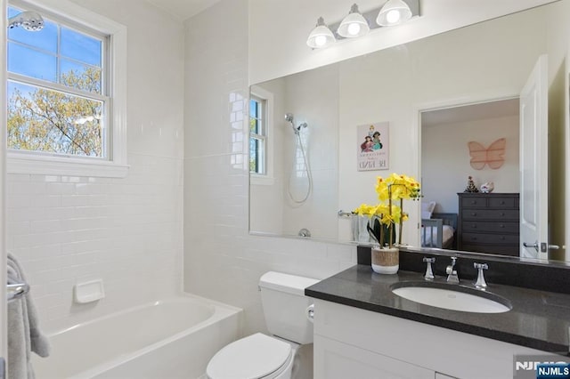50 Constitution Way Unit 50, Jersey City, NJ 07305 - bathroom featuring plenty of natural light, vanity, bathtub / shower combination, and tile walls