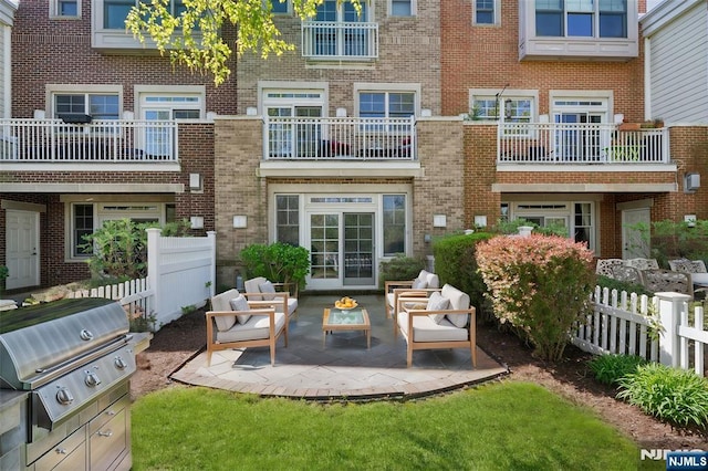 50 Constitution Way Unit 50, Jersey City, NJ 07305 - rear view of property featuring brick siding, outdoor lounge area, and a patio