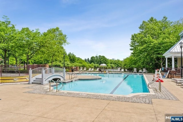 50 Constitution Way Unit 50, Jersey City, NJ 07305 - community pool with a patio area and view of wooded area