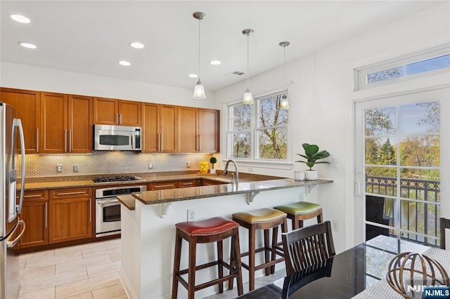 50 Constitution Way Unit 50, Jersey City, NJ 07305 - kitchen featuring stainless steel appliances, dark stone counters, plenty of natural light, backsplash, and recessed lighting