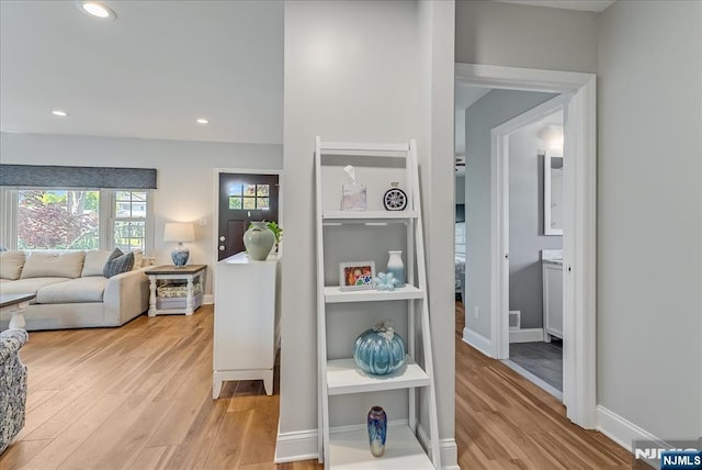 hall featuring recessed lighting, light wood-style flooring, and baseboards
