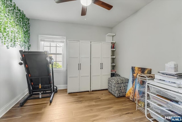 office featuring baseboards, a ceiling fan, and light wood finished floors