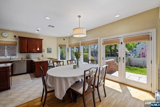 dining space featuring recessed lighting, visible vents, french doors, and light wood-style floors