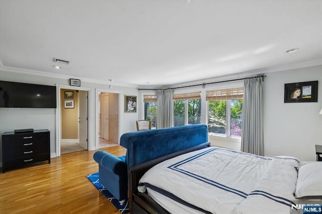 bedroom with visible vents, crown molding, baseboards, recessed lighting, and light wood-style flooring