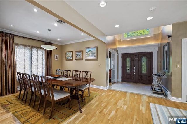 dining room featuring visible vents, ornamental molding, baseboards, recessed lighting, and light wood-type flooring