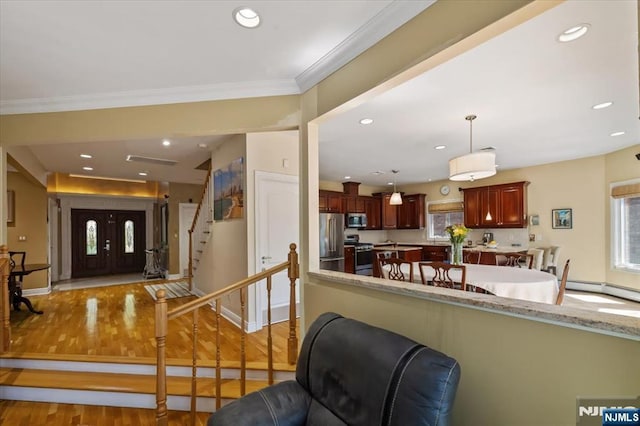 living area with recessed lighting, light wood-type flooring, and a wealth of natural light