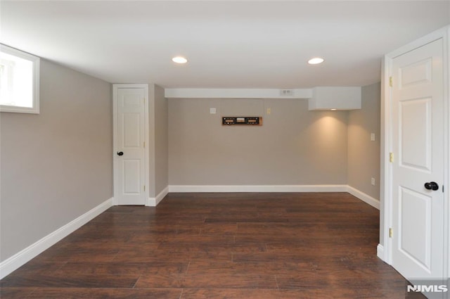 finished basement featuring recessed lighting, baseboards, and wood finished floors