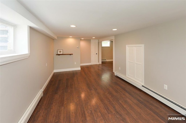 spare room with recessed lighting, a baseboard heating unit, baseboard heating, and dark wood finished floors