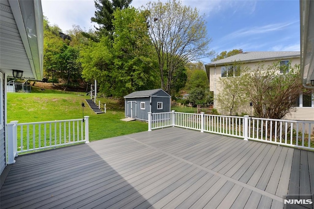 deck featuring a lawn, an outbuilding, and a shed