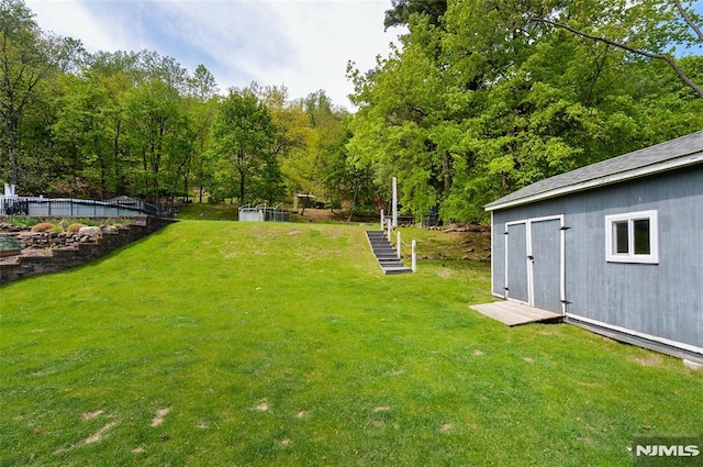 view of yard featuring a storage shed and an outbuilding