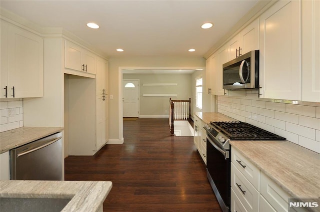 kitchen with white cabinets, stainless steel appliances, and recessed lighting