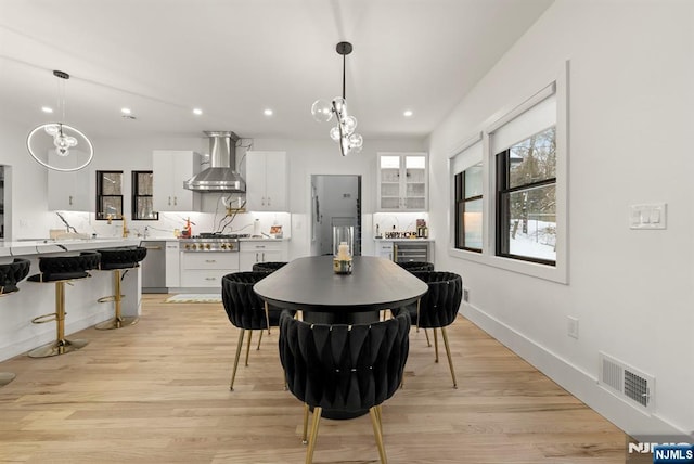 dining room with a chandelier, visible vents, light wood-style flooring, and recessed lighting