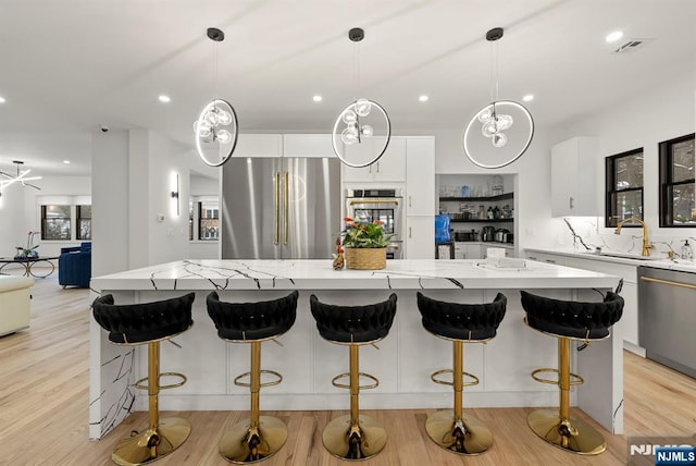 kitchen featuring visible vents, a large island, recessed lighting, and stainless steel appliances