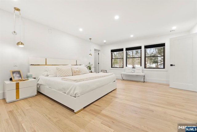 bedroom with light wood-style floors, recessed lighting, and baseboards