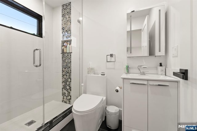 bathroom with toilet, a shower stall, and vanity