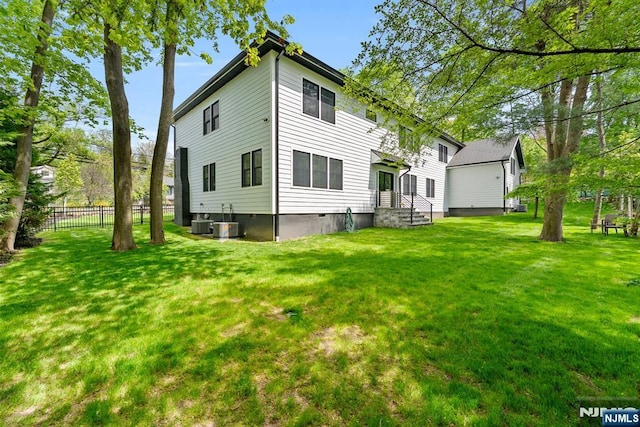 534 Closter Dock Rd, Closter, NJ 07624 - back of property with a lawn, fence, and central air condition unit