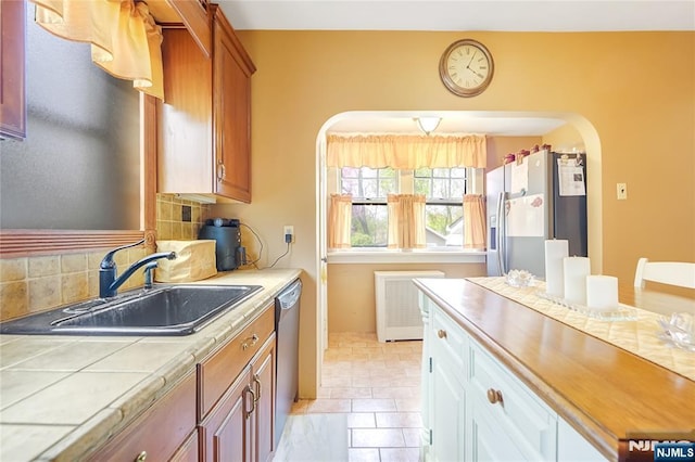6 Colonial Ct, Dumont, NJ 07628 - kitchen with a sink, arched walkways, tile countertops, stainless steel dishwasher, and refrigerator with ice dispenser