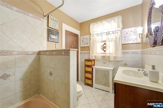 6 Colonial Ct, Dumont, NJ 07628 - bathroom featuring vanity, tile patterned floors, radiator heating unit, tile walls, and a bath